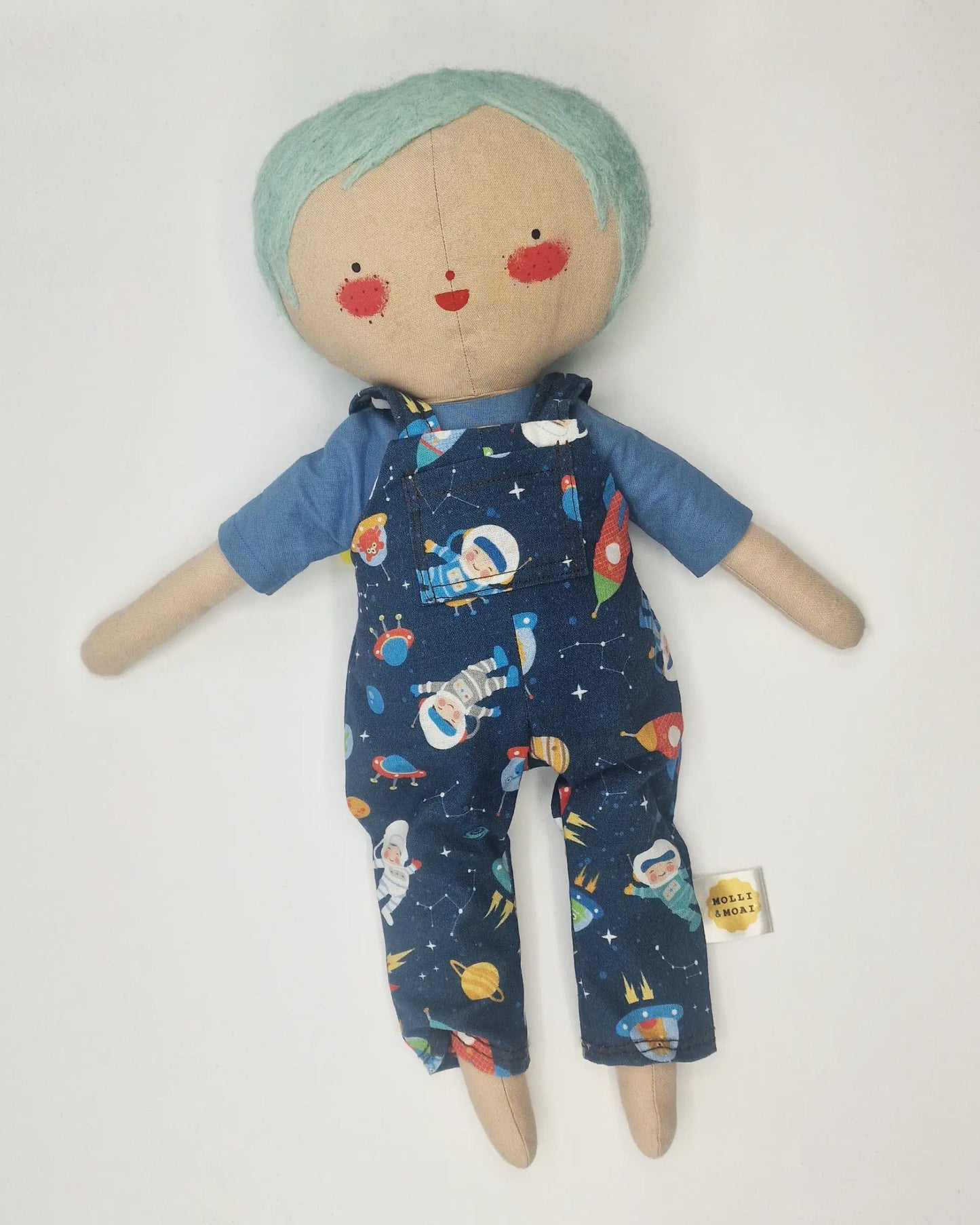 Handmade Daisy doll with light green wool hair, wearing space-themed dungarees and a blue shirt, featuring a cheerful hand-painted face.