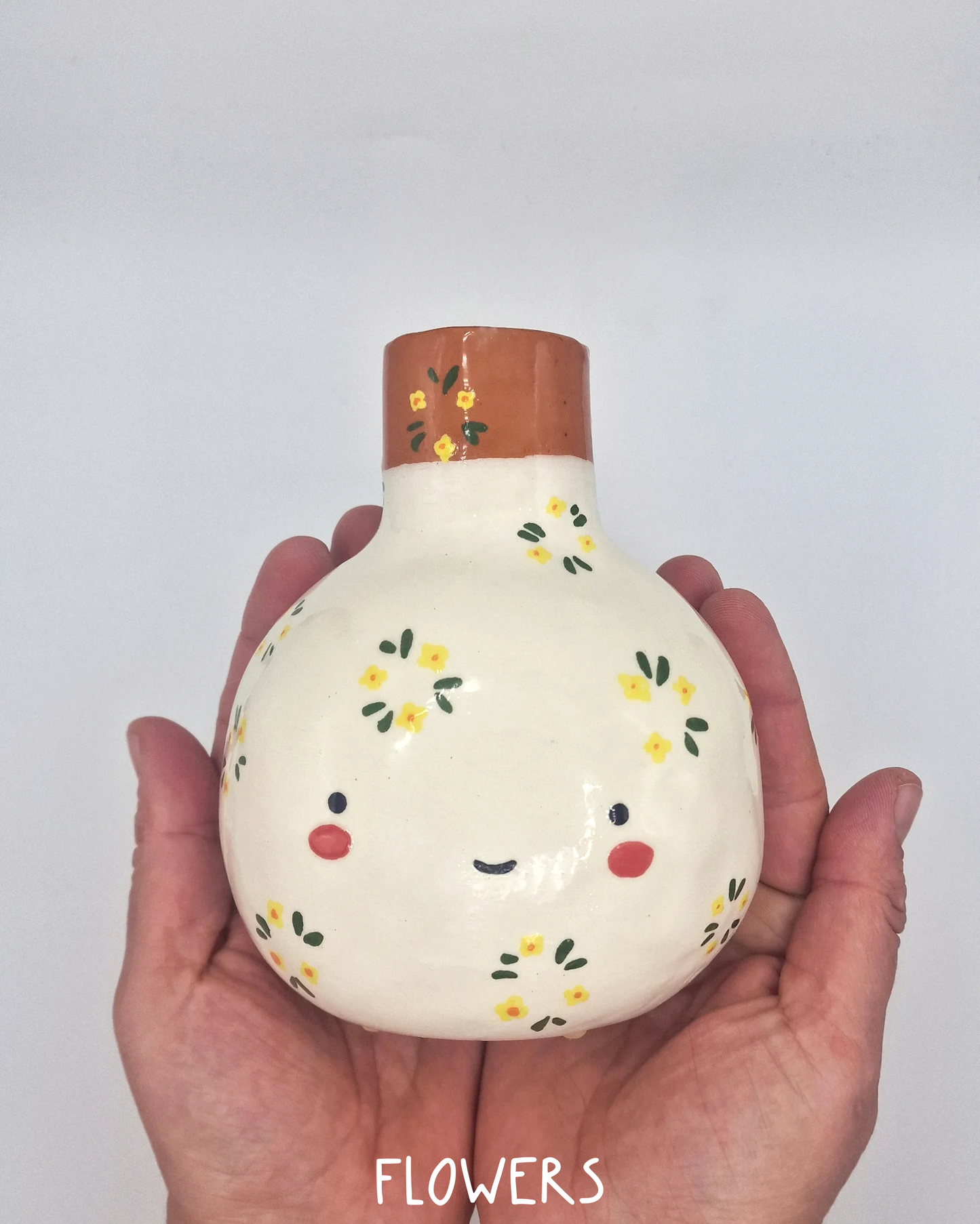 Decorative ceramic vase with floral patterns on a white background